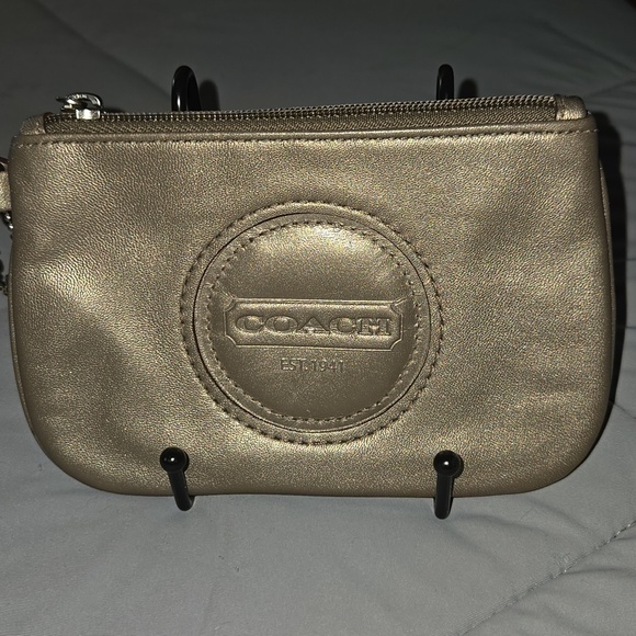 Coach Handbags - Coach metallic bronze wristlet featuring a detachable strap and a embossed logo